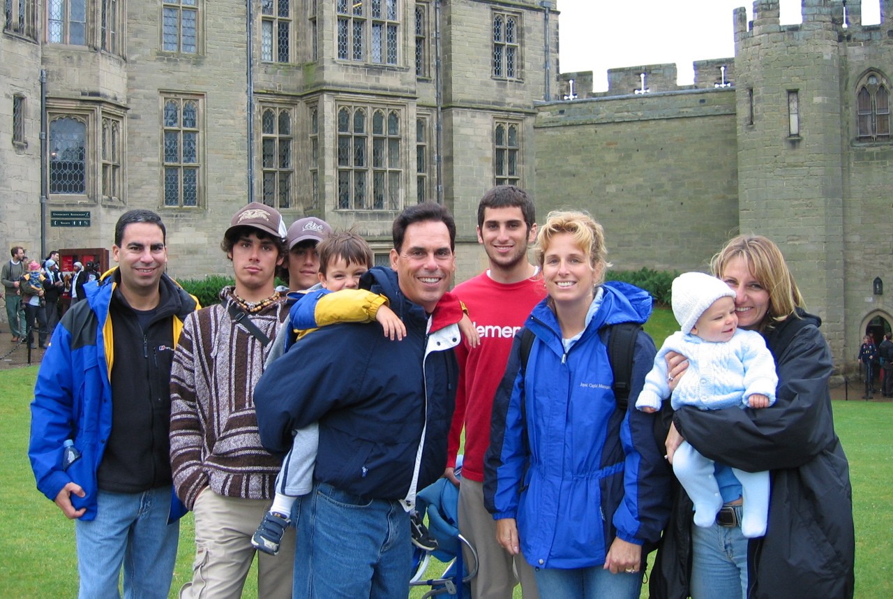 family posing together in front of a castle